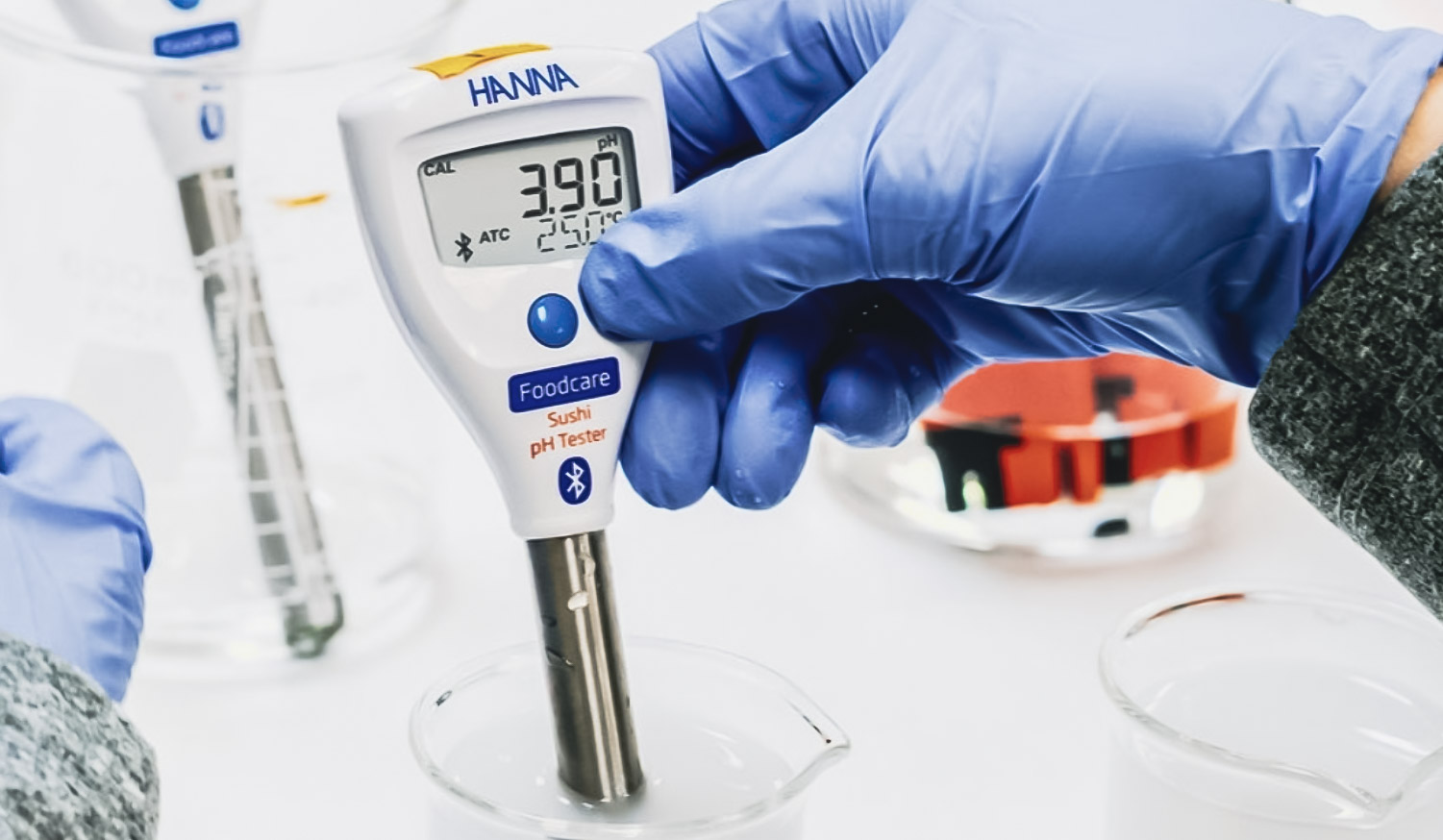 a close-up image of a Halo2 pH tester measuring sushi rice
